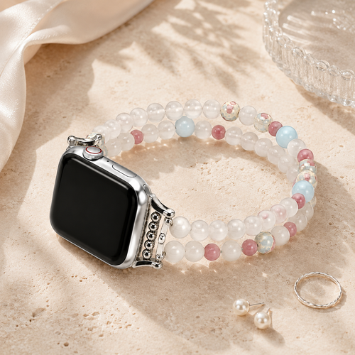 Ins-style flat lay of pastel beaded Apple Watch bracelet with jewelry accents on neutral beige textured background