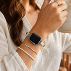 Woman wearing a natural stone beaded Apple Watch band with layered silver and pearl bracelets