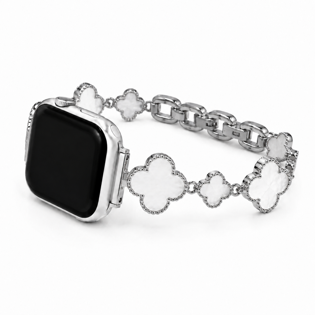Close up detail of shell four-leaf clover charms on Apple Watch bracelet