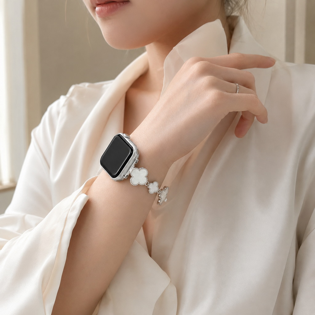 Mother of Pearl clover Apple Watch band worn on a woman's wrist