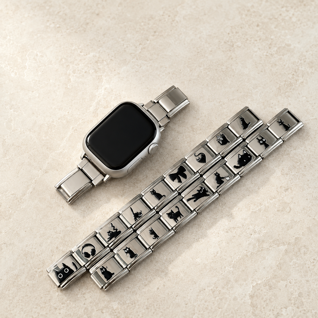 Silver cat Apple Watch band styled with jewelry in a light luxury flat lay